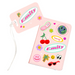 A pink personalised passport holder and matching luggage tag set featuring colourful stickers and the name Emily printed in a retro-style font. Both items include cheerful travel-themed designs such as cherries, palm trees, and smiley icons.