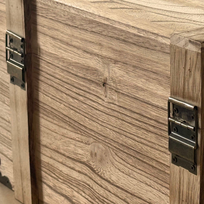 Close-up of a wooden cabinet with metal hinges