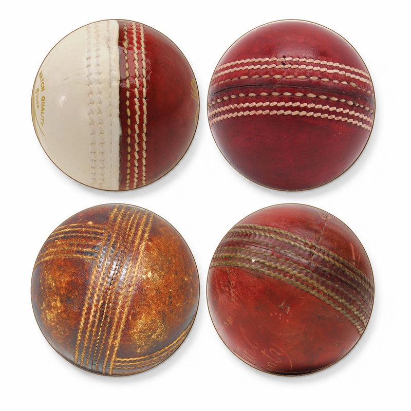 Four vintage cricket balls arranged in a 2x2 grid on a plain white background, showing different stages of aging and wear.