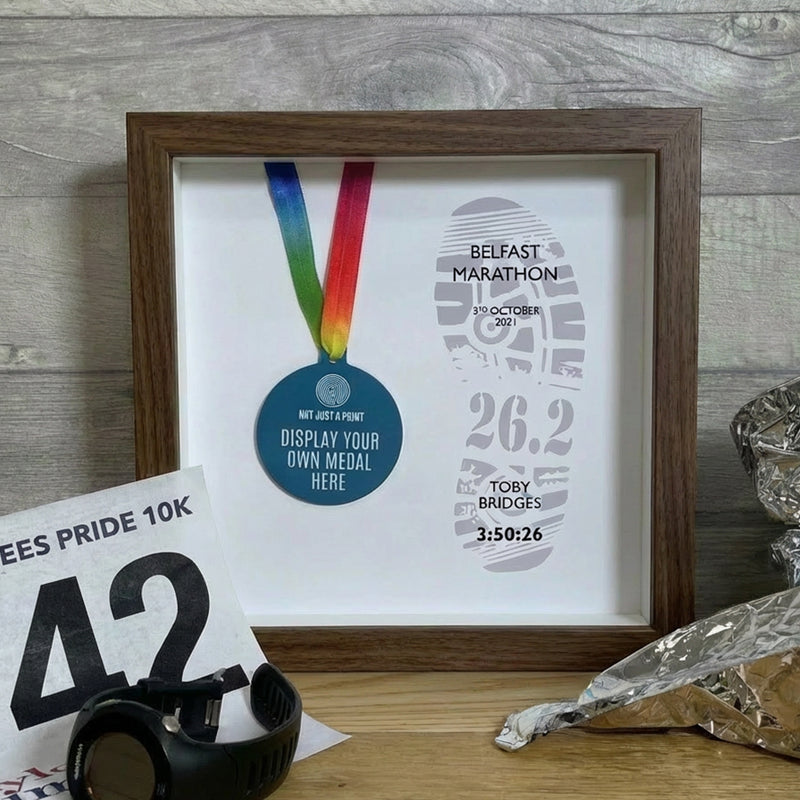 marathon medal inside a dark wood frame
