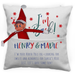 Decorative pillow with Elf on the Shelf design and text 'I'm Back! HENRY & MADIE'.
