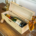 Engraved wooden champagne gift box open to reveal a bottle of Moët & Chandon, surrounded by filled flutes and golden festive decor.