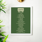 Framed Oasis 'Live '25' album tracklist on a white wall with plants.