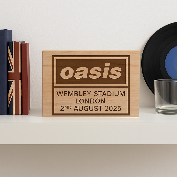 Oasis engraved wooden sign displayed on a white shelf beside books and a vinyl record, creating a modern music-themed home decor se
