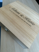 Personalised wooden wine box engraved with names and romantic message, shown at an angle to highlight the engraved text and clasp.