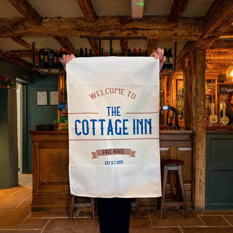 Personalized pub tea towel with 'Welcome to The Cottage Inn' design