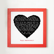 A framed lyric print with a black heart filled with the lyrics of “In My Life.” The design is framed in bright red and includes the text “In my life I love you more” followed by “Happy Anniversary!” The striking contrast of red, black, and white gives the piece a bold, romantic look.