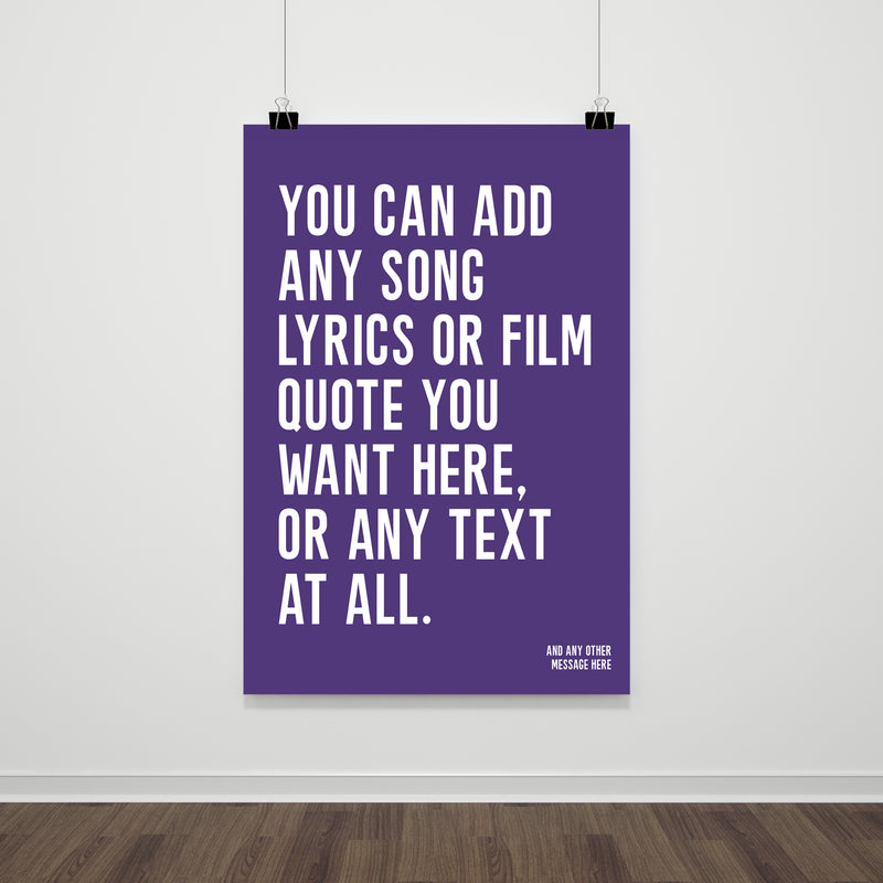 A large poster with a purple background and bold white text that reads: “You can add any song lyrics or film quote you want here, or any text at all.” The customizable message is printed in a simple, modern font and hung on a plain white wall with black clips.