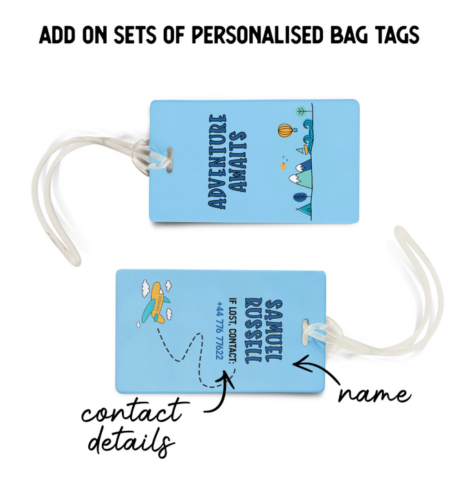 Two personalised blue luggage tags with matching “Adventure Awaits” designs. One side displays the phrase with a plane and mountain illustration, while the reverse shows the name “Samuel Russell” and contact details. Text annotations highlight the custom name and contact info options.