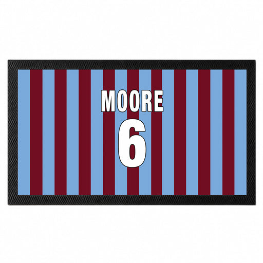 A rectangular mat with a black border and vertical blue and maroon stripes, featuring the text 'MOORE 6' in white with black outlines in the center.