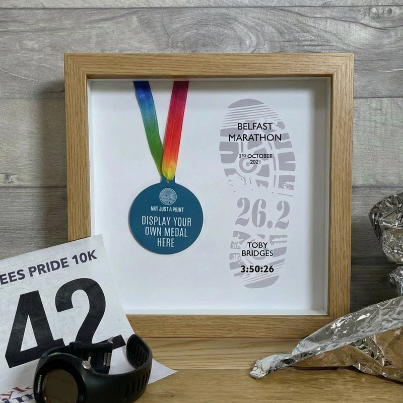 marathon medal inside a oak frame