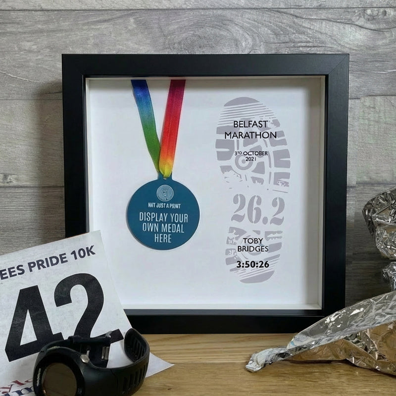 marathon medal inside a black and frame