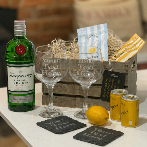 tanqueray Dry Gin bottle with two glasses, coasters, and cans on a table.