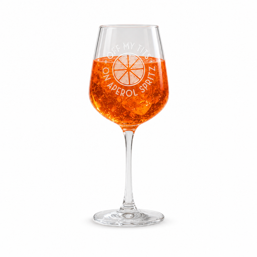 Engraved Off My Tits on Aperol Spritz wine glass in a garden setting