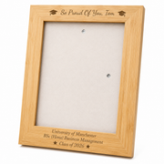 Personalised bamboo graduation photo frame engraved with the graduate's name, university, degree and graduation year, displayed with a graduation portrait.