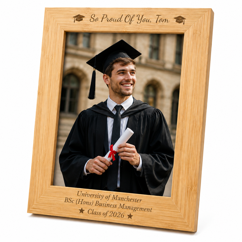 Personalised bamboo graduation photo frame engraved with graduate's name, university, degree and year, displayed with a graduation portrait