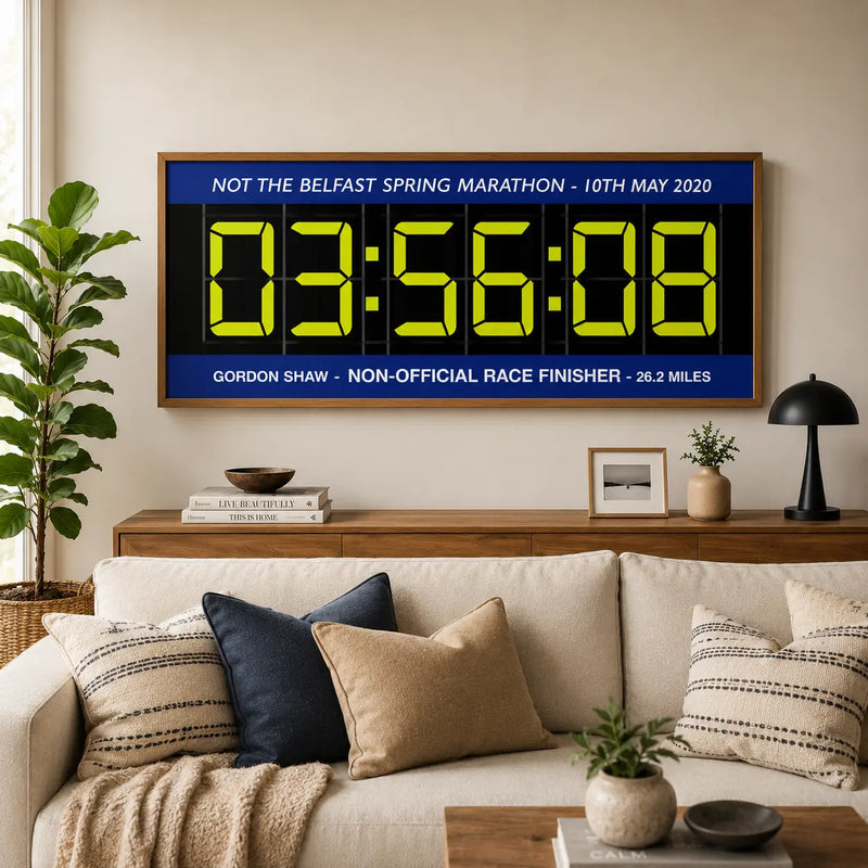 Large digital timer race print in oak frame above sofa