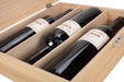 Interior of a wooden wine gift box with three compartments holding Syrah wine bottles.