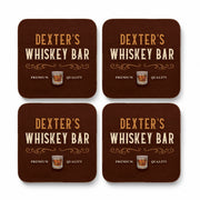 Set of four personalised whisky coasters with custom name and traditional wood effect whisky bar design
