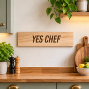 YES CHEF engraved wooden sign displayed on a kitchen wall