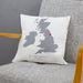 Personalised cushion featuring a grey map of the United Kingdom with a red heart marking a special location, and text reading “Mr & Mrs Robinson, Bardale Hall, 10th October 2016,” displayed on a grey chair.
