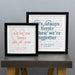 Two framed prints are displayed on a gray tabletop against a plain wall. The smaller frame on the left reads “All of me loves all of you” in pink text, with a personalized message below: “Steve & Verity — Happy 10th Anniversary 27.12.2021.” The larger frame on the right reads “It’s always better when we’re together” in blue text, with “Mr & Mrs Robinson — 27.10.2007” written below. Both prints have faint song lyrics or text in the background forming a heart shape.